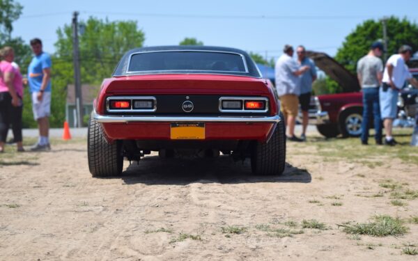 A red car parked on top of a dirt road — Canandaigua: The Finger Lakes' Grand Main Street Town