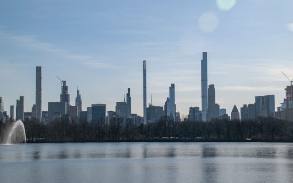 A large body of water with a city in the background — Corning: The Crystal City at the Finger Lakes' Southern Edge