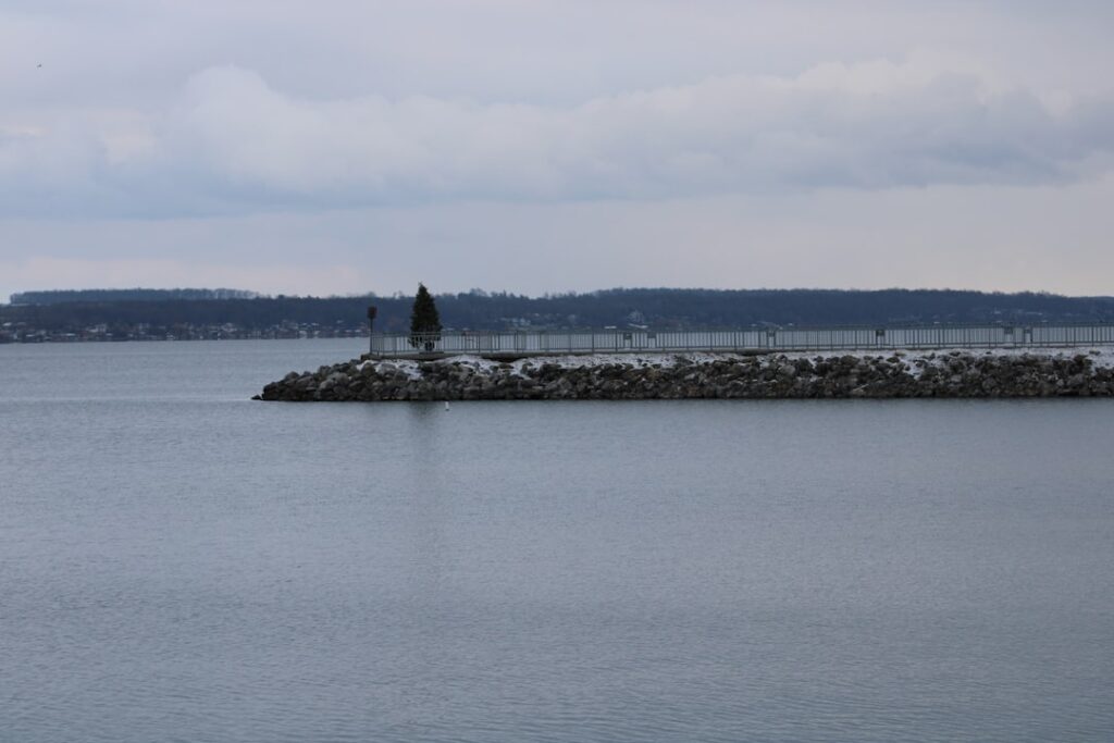 A large body of water with a small island in the middle of it