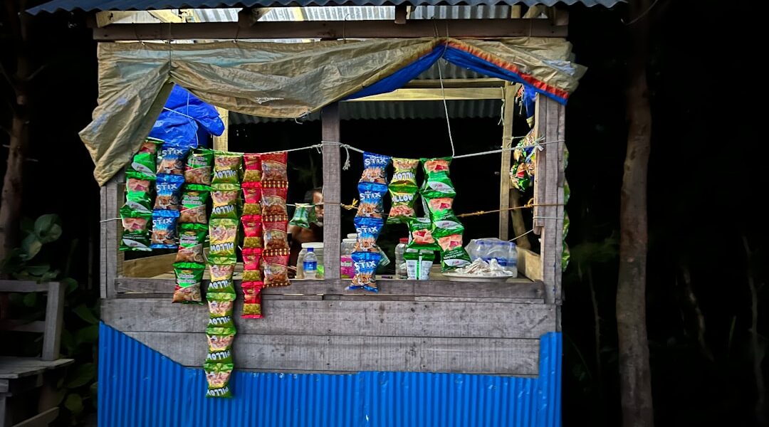 A small shop with a blue awning and a blue awning — Black Button Distilling