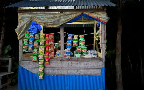 A small shop with a blue awning and a blue awning — Black Button Distilling