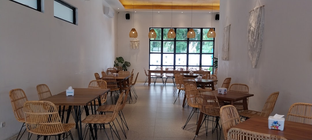 A restaurant with wicker tables and chairs — Hazelnut Kitchen