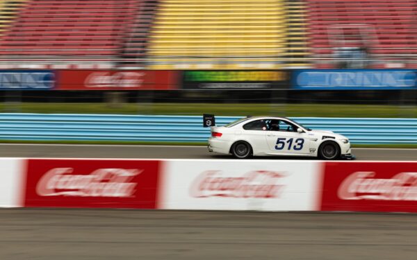 A white car driving down a race track — Can You Swim at Watkins Glen State Park? Here's the Deal
