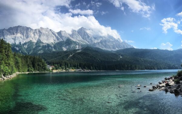 A lake surrounded by trees and mountains under a cloudy sky — Finger Lakes Fall Foliage: When to Go and Where to See It