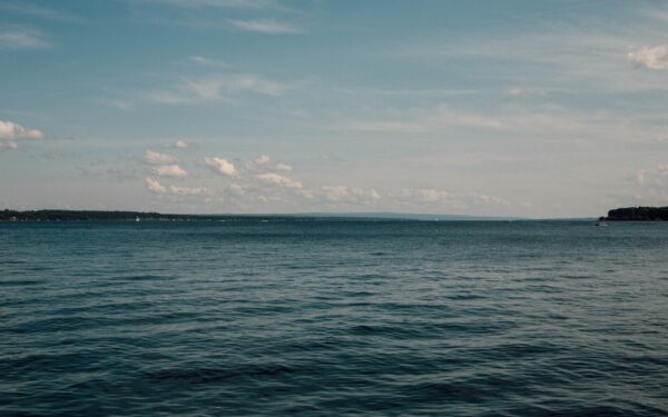Body of water under blue sky — Keuka Lake vs. Seneca Lake: Which One Should You Visit?