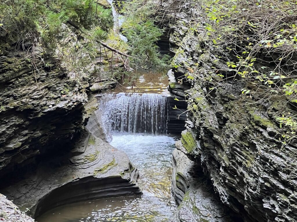 A small waterfall in the middle of a canyon