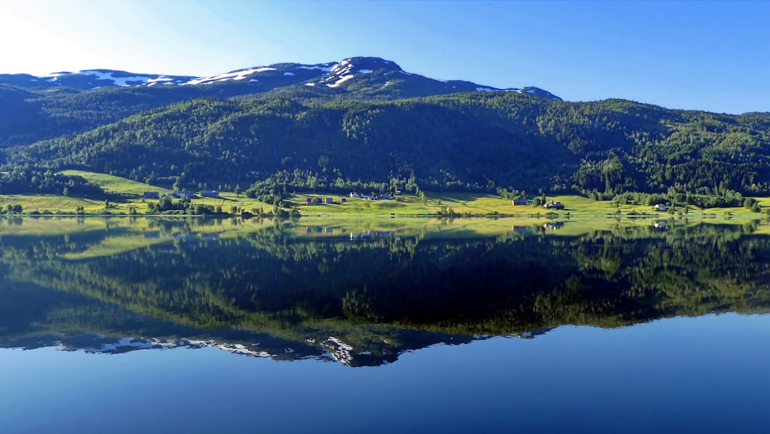 Green grass field near lake during daytime — Where to Stay in the Finger Lakes: Picking the Right Town as Your Base