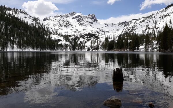 Lake near snow covered mountain during daytime — Finger Lakes in January and February: The Off-Season Guide
